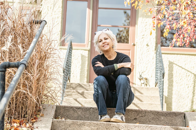 Kate DiCamillo - sitting on her steps. -Photographs by Joe Treleven