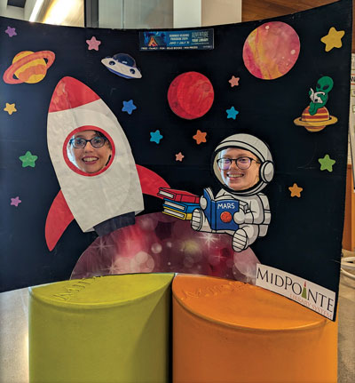 Kids pose with their ocean-themed crafts in a photo booth at the Agave Public Library in Phoenix, AZ.