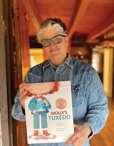 Vicki Johnson with her book Molly’s Tuxedo, Photo courtesy of Vicki Johnson